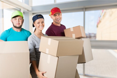 Careful packing of fragile household items in Highbury
