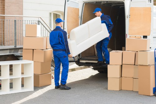 Careful packing and lifting of household items by removalists