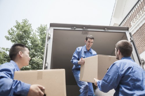 Moving boxes and furniture being loaded for a local Highbury move