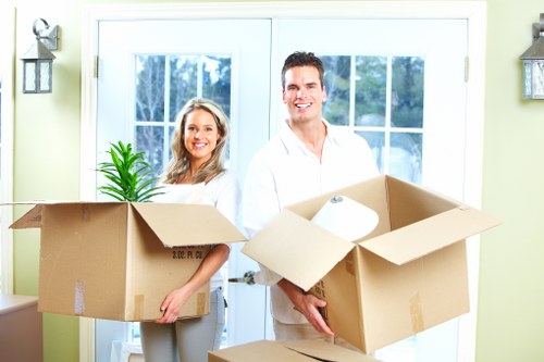 Trained removals staff handling boxes carefully during a move