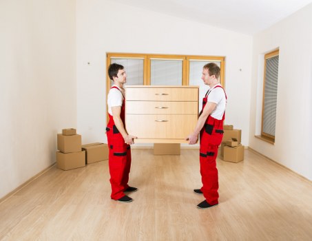 Removal team handling furniture with care during loading